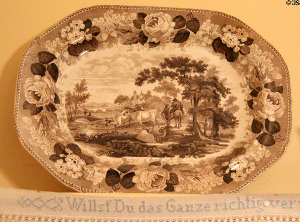 Transfer print platter over embroidered German saying at Edward Steves Homestead Museum. San Antonio, TX.