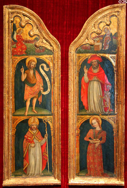 Altarpiece wings (prior to 1446) by circle of Ottaviano di Martino Nelli shows two Angels of Annunciation over St John the Baptist, St Zenobius, St Jerome & St Agatha at McNay Art Museum. San Antonio, TX.
