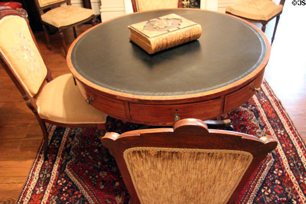 Round renters' table where each boarder had a locked drawer for personal storage in parlor at McCulloch House. Waco, TX.