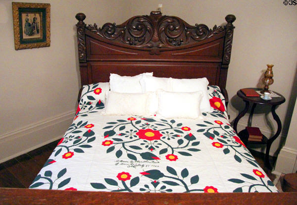 Carved bed with quilt made by Mrs. Ann Rawes (July 25, 1860) at McCulloch House. Waco, TX.