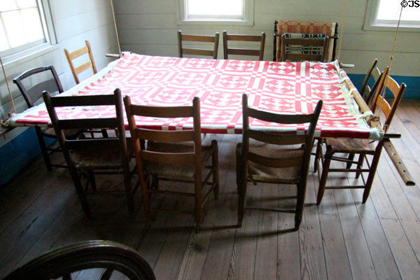 Community quilting table with ropes to move up to ceiling when not in use at John Jay French Museum. Beaumont, TX.