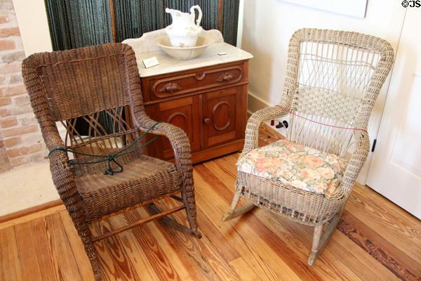 Wicker rocking chairs, pitcher, basin & washstand at Susanna Dickinson Museum House. Austin, TX.