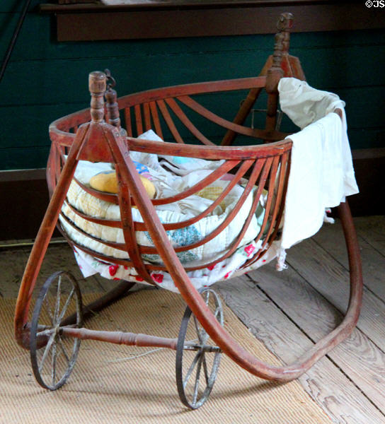Rocking cradle with wheels in Bell House at Pioneer Farms. Austin, TX.