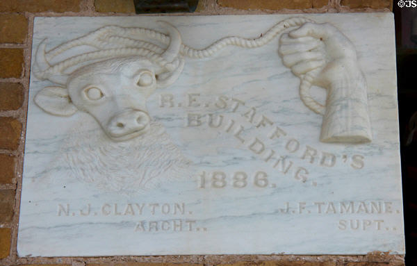 Cornerstone (1886) of Old Stafford Opera House with lassoing steer & architect's name. Columbus, TX.