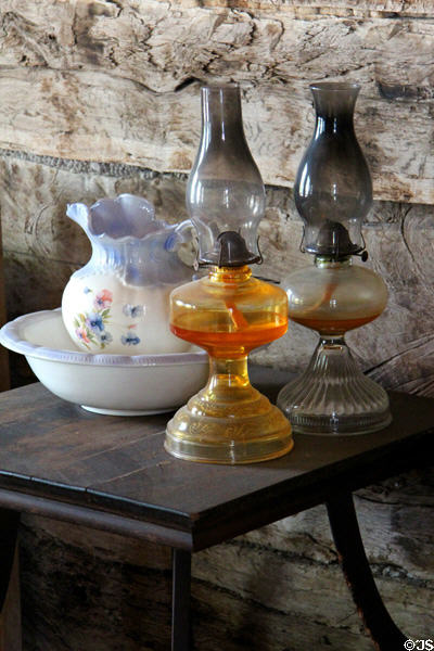 Pitcher & basin with kerosene lamps at Pioneer Village. Gonzales, TX.