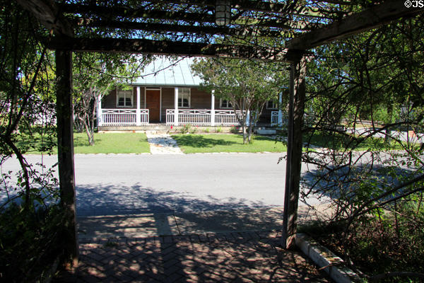 View of Jahn House from arbor at Conservation Plaza. New Braunfels, TX.