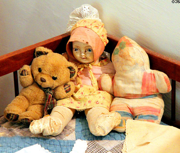 Porcelain face doll & stuffed toys in Jahn House at Conservation Plaza. New Braunfels, TX.