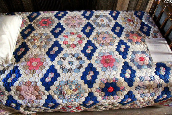Patchwork quilt with floral design in Moehrig Blank House at Conservation Plaza. New Braunfels, TX.
