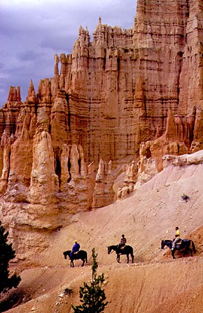 Horse riders pass hoodoos in Bryce Canyon National Park. UT.
