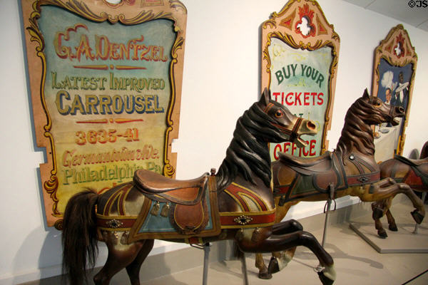 Dentzel Carousel signs & horses in circus building at Shelburne Museum. Shelburne, VT.