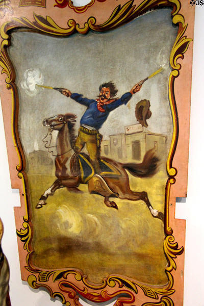 Carousel painted panel of Rough Rider firing two six-guns symbolic of Spanish-American War (c1898) in circus building at Shelburne Museum. Shelburne, VT.