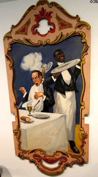 Carousel painted panel of black waiter dropping coffee on diner (c1898) in circus building at Shelburne Museum. Shelburne, VT.