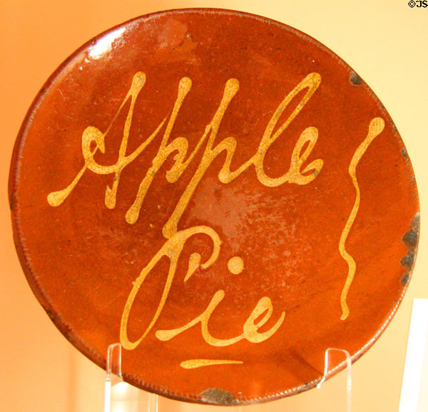 Redware plate (19thC) trailed slip decorated stating "Apple Pie" at Shelburne Museum. Shelburne, VT.