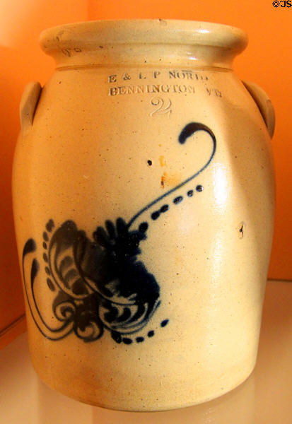 Stoneware crock (1861-82) painted with feathers by E&LP Norton & Co. of Bennington, VT at Shelburne Museum. Shelburne, VT.