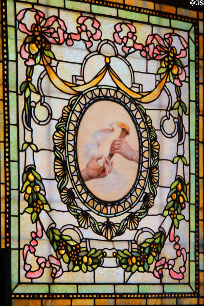 Stained glass window with hand passing torch at Marsh-Billings-Rockefeller Mansion. Woodstock, VT.
