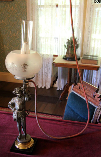 Table gas lamp fed by hose from ceiling lamp in farm house parlor at Billings Farm & Museum. Woodstock, VT.