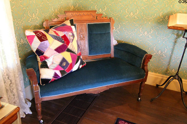 Sofa with carved back in farm house parlor at Billings Farm & Museum. Woodstock, VT.