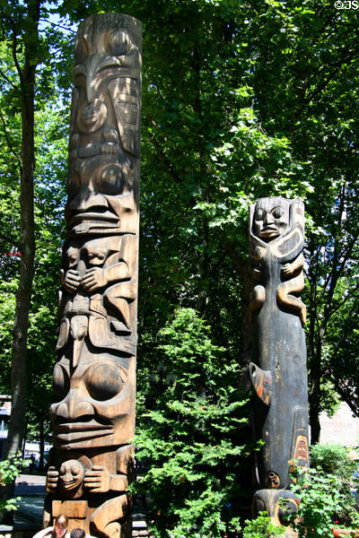Totem poles (1980s) by Duane Pasco in Occidental Park of Pioneer Square historic district. Seattle, WA.