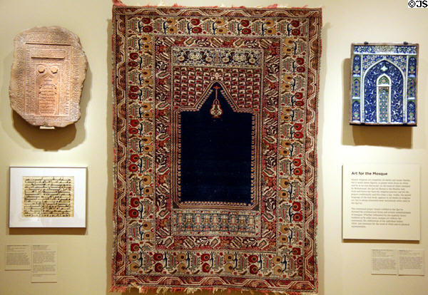Islamic art at Seattle Art Museum with an Anatolian prayer rug (late 19th-early 20thC), Persian tombstone (1143) & tile (18thC). Seattle, WA.