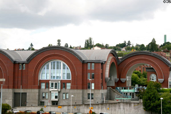 Washington State History Museum with arches against hills of Tacoma. Tacoma, WA.