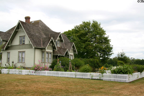 White picket fence & gardens around Hovander Homestead house. Ferndale, WA.