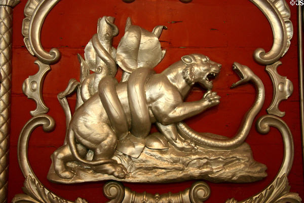 Carving of tiger battling a snake on red & silver circus wagon at Circus World Museum. Baraboo, WI.