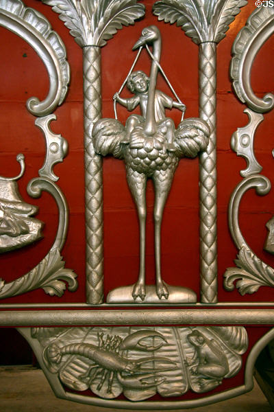 Carving of child riding an ostrich on red & silver circus wagon at Circus World Museum. Baraboo, WI.