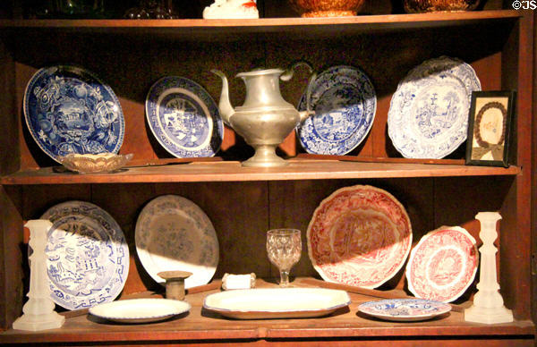 Corner cupboard with ceramic plates in settlers' cabin at West Virginia State Museum. Charleston, WV.