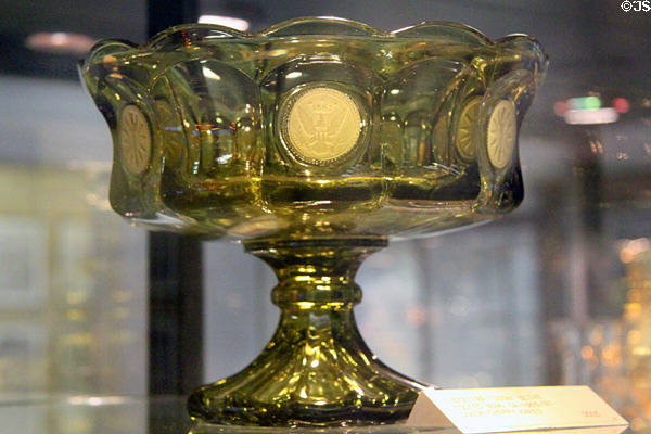 Coin glass footed compote in olive (1965-81) at Fostoria Glass Museum. Moundsville, WV.