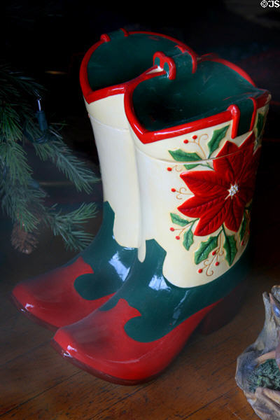 Ceramic Christmas cowboy boots in shop window. Cody, WY.