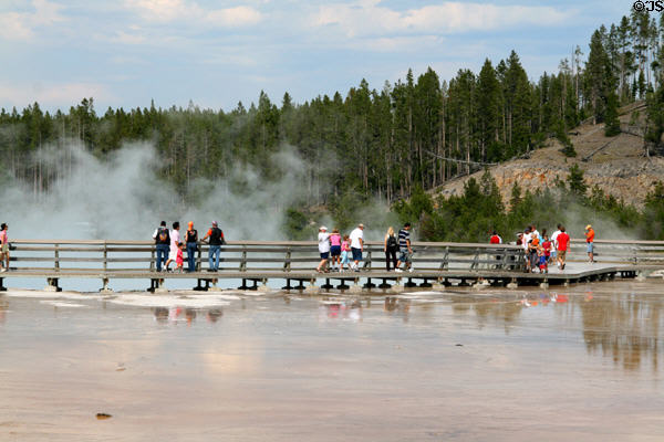 Visitors on raised walkway above Excelsior Geyser of Yellowstone National Park. WY.