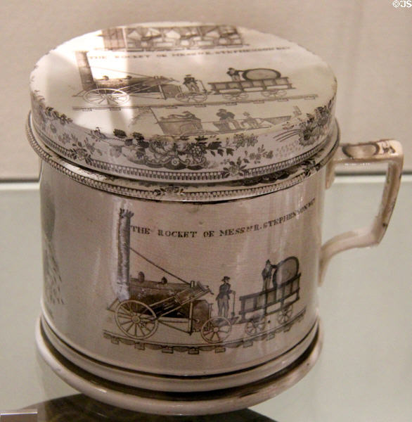 Transfer-printed shaving mug showing locomotives Stephenson's Rocket plus Braithwaite & Ericsson's Novelty competing in trials for Liverpool 7 Manchester Railway (c1829) by Herculaneum Pottery, Toxteth, Liverpool at Walker Art Gallery. Liverpool, England.