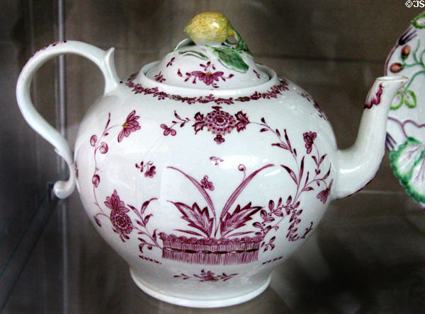 Soft-paste porcelain punch pot (1760-62) with purple on white design & fruit ornament on cover made in Derby at National Museum of Wales. Cardiff, Wales.