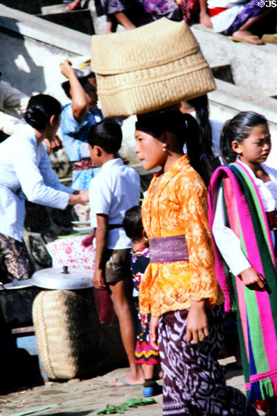 Woman with basket on temple day. Bali, Indonesia.