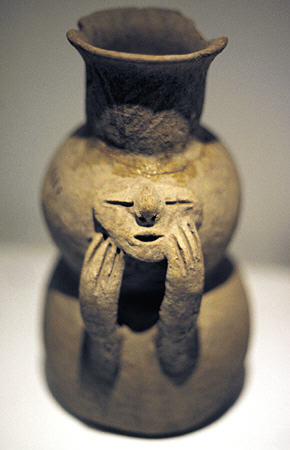 Qotakalli jug of face leaning on hands (600) in Inca Museum, Cusco, found in Cusco region. Peru.