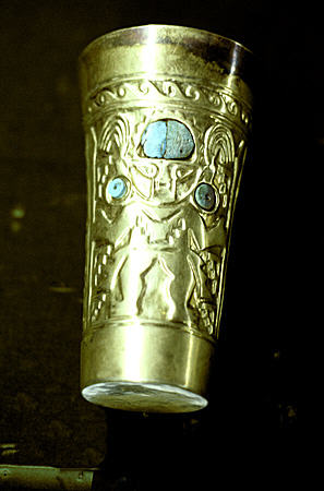 Lambayeque beaker in gold & turquoise with human figure in Lima's Gold Museum. Peru.