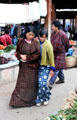 A family looks at vegetables for sale at Saturday market in Thimpu. Bhutan.