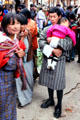 Sleeping child being carried through Thimpu's Saturday market. Bhutan