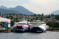 Catamaran ferries Pacificat Discovery & Explorer at shipyard against North Vancouver. Vancouver, BC.