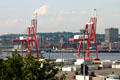 Container port cranes loom over Saint John harbor. Saint John, NB.