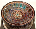Fritware bowl painted blue & brown with bird & Arabic script from Iran at Aga Khan Museum. Toronto, ON.