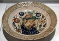Fritware dish with underglaze painting of court character from Iran at Aga Khan Museum. Toronto, ON.