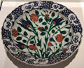 Fritware dish painted with flowers from Iznik, Turkey at Aga Khan Museum. Toronto, ON.