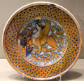 Majolica dish with coat of arms held by sphinx from Deruta, Italy at Gardiner Museum. Toronto, ON.