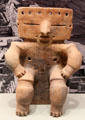 Quimbaya earthenware seated figure with gold nose ring from Colombia at Gardiner Museum. Toronto, ON.