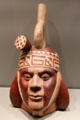 Moche culture earthenware portrait bottle with stirrup spout from North Coast Peru at Gardiner Museum. Toronto, ON.