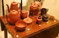 English & Bohemian red stoneware vessels atop Mahogany veneered English table at Royal Ontario Museum. Toronto, ON.