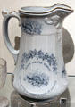 Earthenware pitcher with blue transfer-print of Canadian beaver under slogan "Labor Omnia Vincit" from England at Royal Ontario Museum. Toronto, ON.