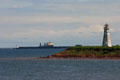 Lighthouse & ship at end of Confederation Bridge to PEI. PE.
