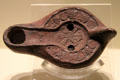 Terracotta late-Roman oil lamp with Christian symbol from North Africa at Montreal Museum of Fine Arts. Montreal, QC.